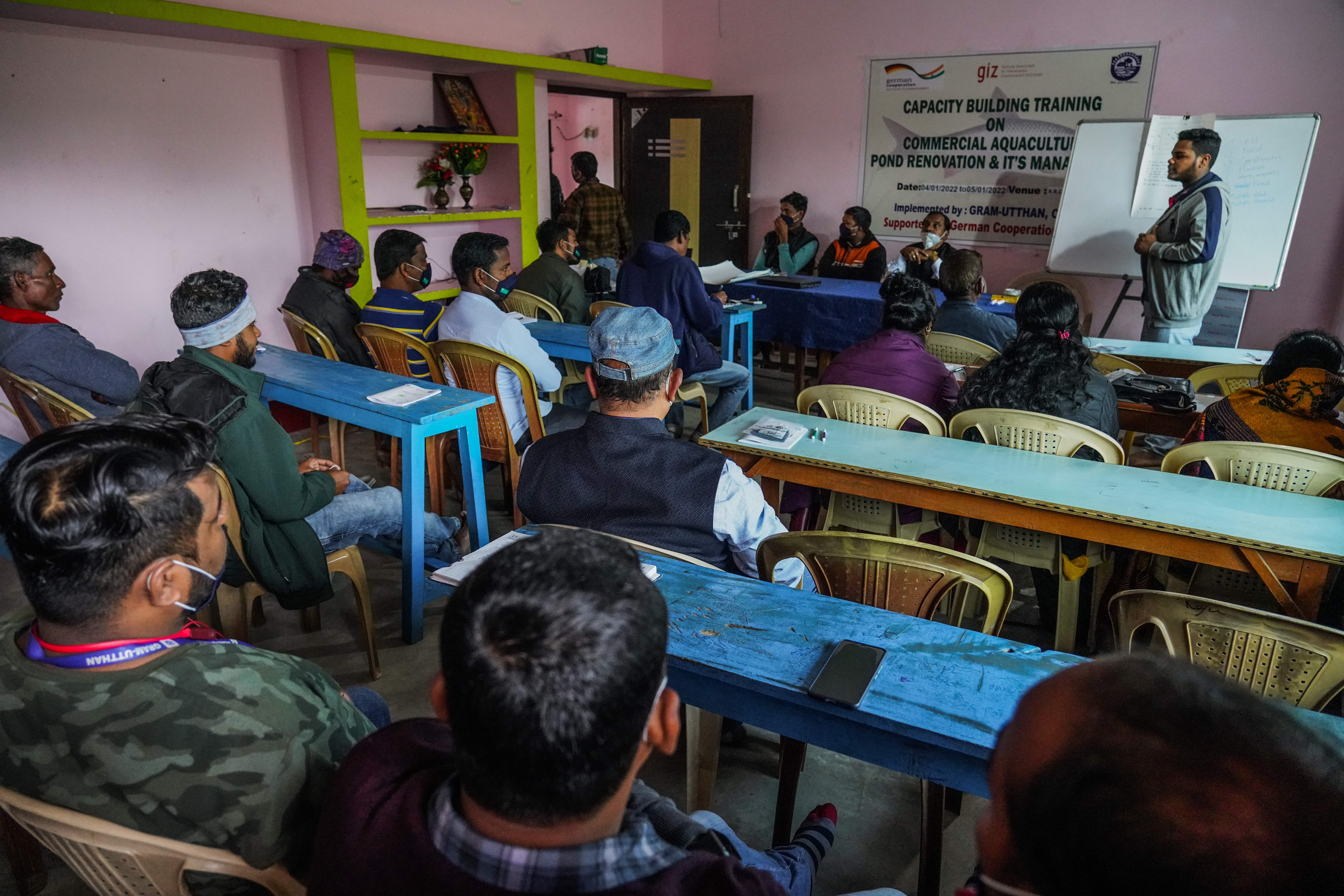 Aquaculture farmer sitting in class room attending a capacity building training on sustainable aquaculutre