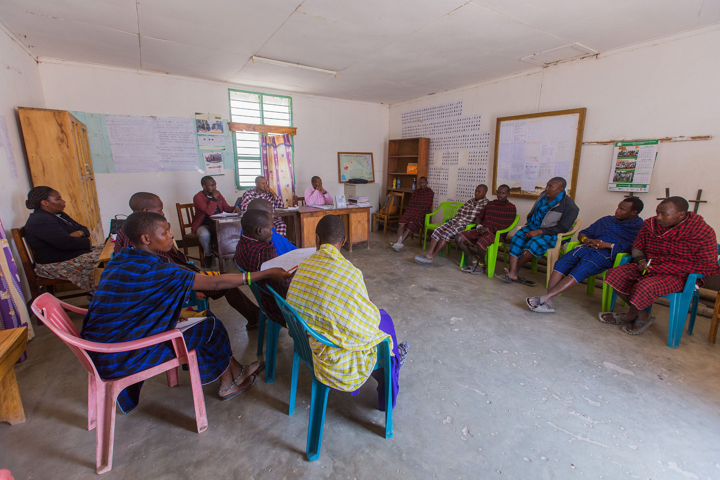 Group of people sit in chairs in a community hall