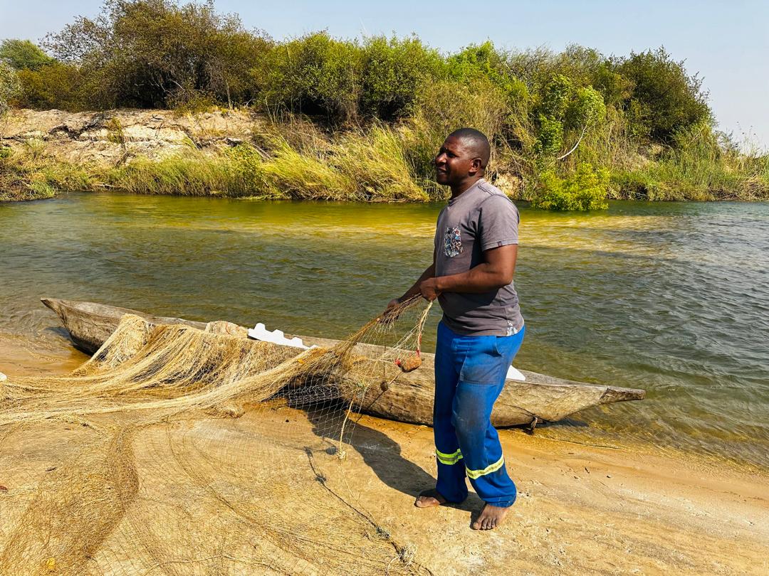 Fisherman in Kalimbeza channel, using the legal fishing net in Zambezi river, found during the joint awareness raising which took place between Zambia and Namibia Fisheries departments.