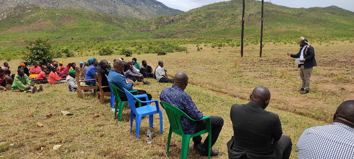 Paramount Chief Gomani V (standing right), Chair of the Chief’s Forum holding a communi-ty meeting to conserve Mvai Forest Reserve 