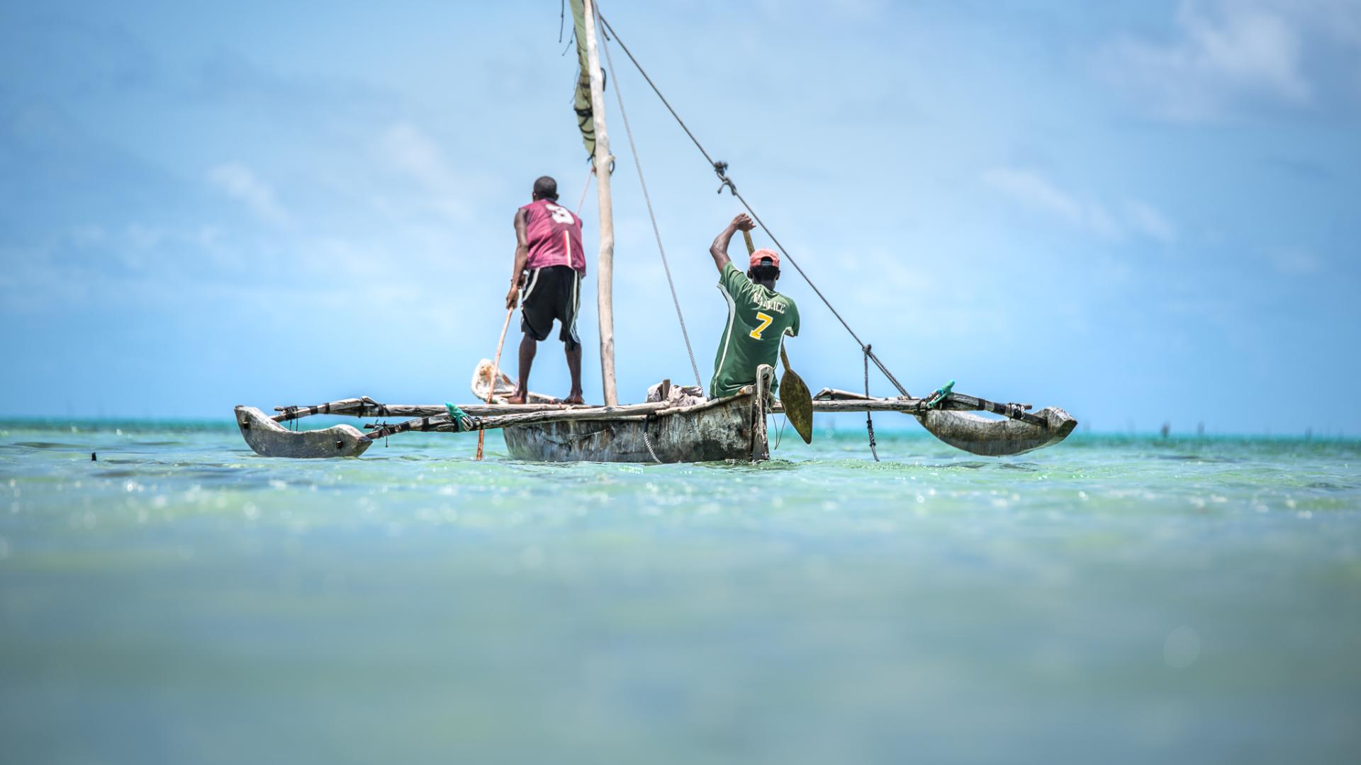 Fishers on boat - Mwambao, Maliasili