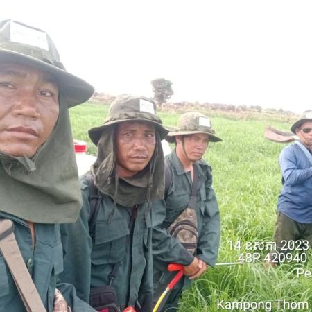 Four members of the Peam Bang Community Fishery Fire Management Team at the site of a fire