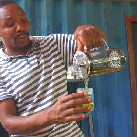 TRI Beneficiary, Antonio Camuenha seen producing one of the tea products supported by The Restoration Initiative. Photo – TRI/STP -FAO