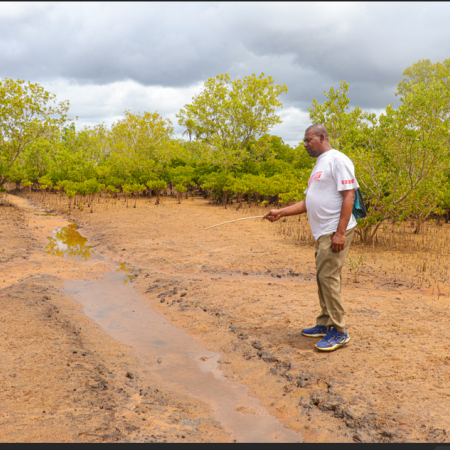 Harith Mohamed at the hydrological channels created within the Jimbo salt pans