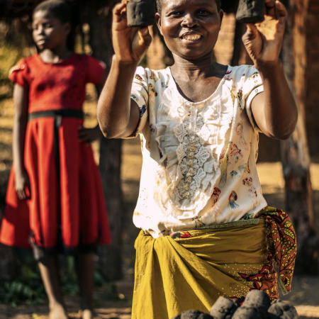 Elizabeth showcasting her own produced briquettes