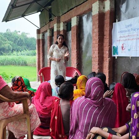 Sandhya leading community session with women in Susta
