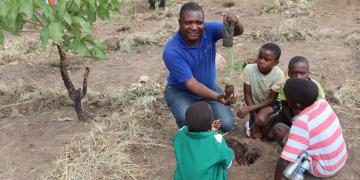 Children in the Kirk Range Mountains taking tree planting lesson