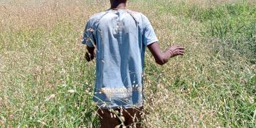 "Community member actively assessing restored sites to evaluate the progress of land rehabilitation efforts and ensure the effectiveness of restoration strategies."