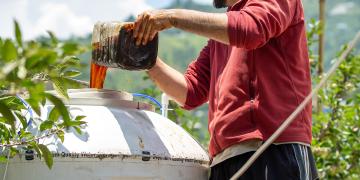 Farmer Filling up Biofermenter