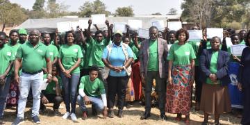 UNDP, Catholic Relief Services (CRS) and Ntcheu District Council officials posing for a group photo with young women and men who have been recognized with certificates under the MGC initiative