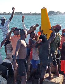 Local fishers place a buoy demarcating a no-take reserve. Rare