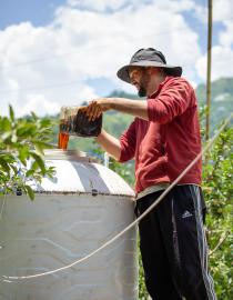 Farmer Filling up Biofermenter