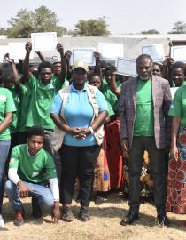UNDP, Catholic Relief Services (CRS) and Ntcheu District Council officials posing for a group photo with young women and men who have been recognized with certificates under the MGC initiative