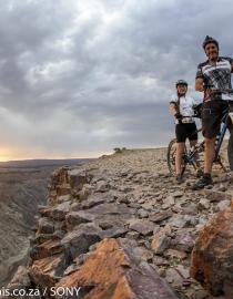 Cycling along the edge of the Fish River Canyon on Day 1 of the Desert Knights Mountainbike Tour, photo by Jacques Marais